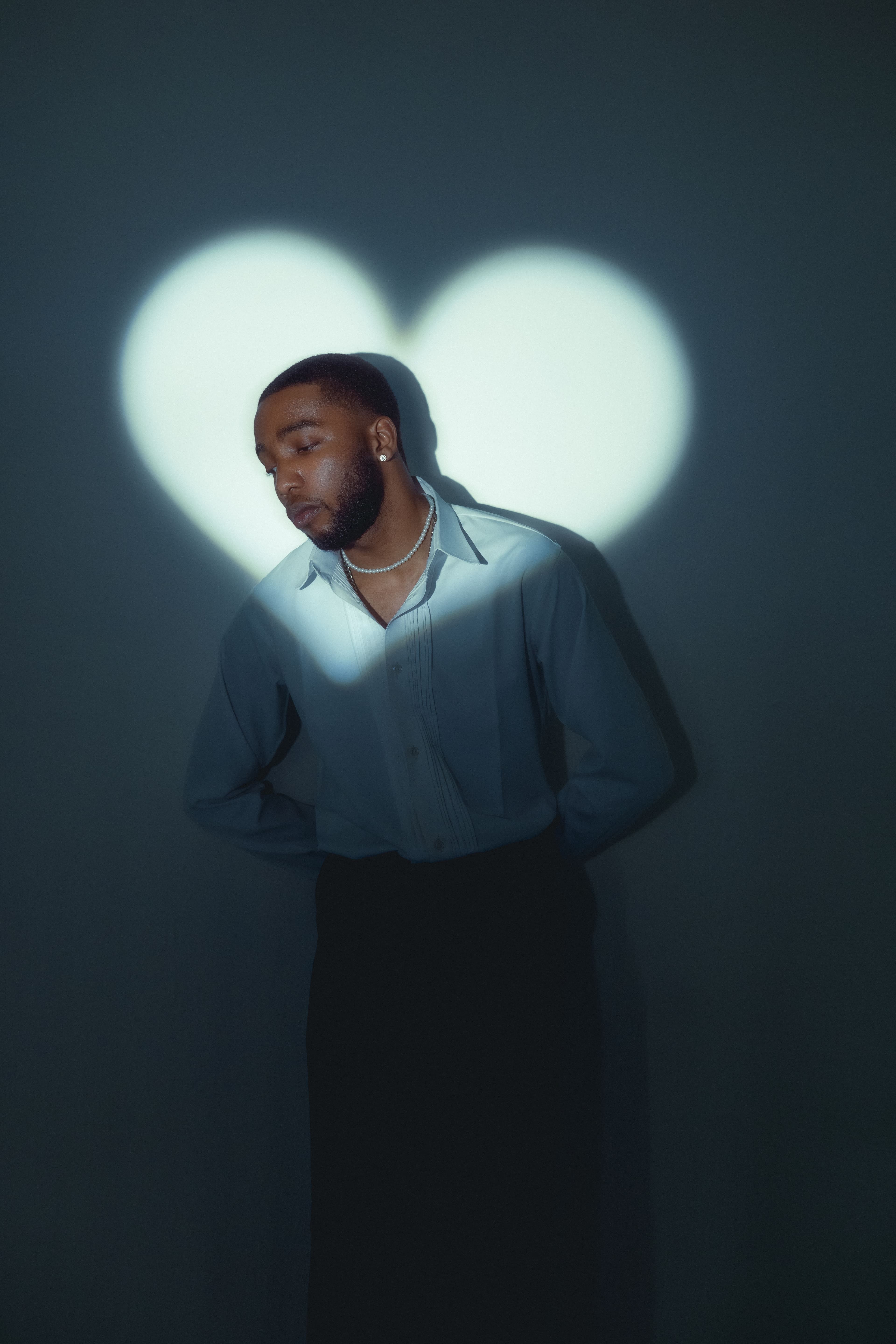 Moody portrait with heart-shaped light